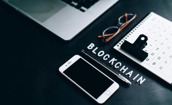 Free Flat lay of a modern digital workspace with blockchain theme, featuring a smartphone and calendar. Stock Photo